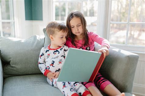 Big Sister Reading A Book For Little Brother By Stocksy Contributor Jakob Lagerstedt Stocksy