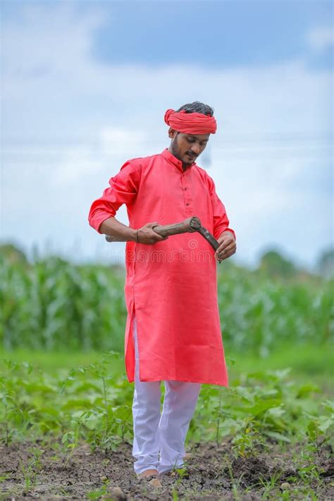 Young Indian Farmer Hard Working With Farm Equipment In His Field Stock