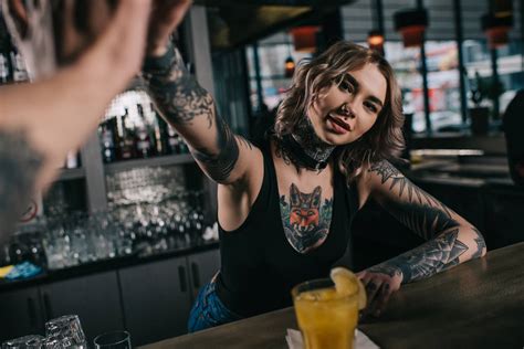 Cropped Image Of Tattooed Bartender Giving High Five To Visitor At Bar Free Stock Photo And Image