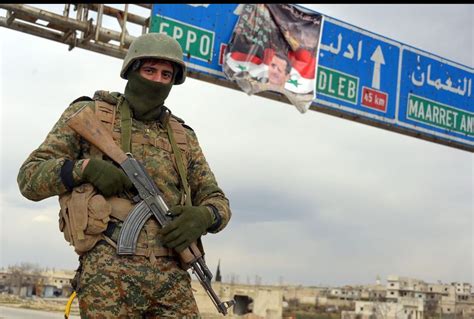 A Soldier Of Syrian Arab Army Patrols The M5 Highway In Maraat Al Numan