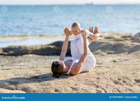 A Mother And A Son Are Doing Yoga Exercises Stock Photo Image Of Female Girl
