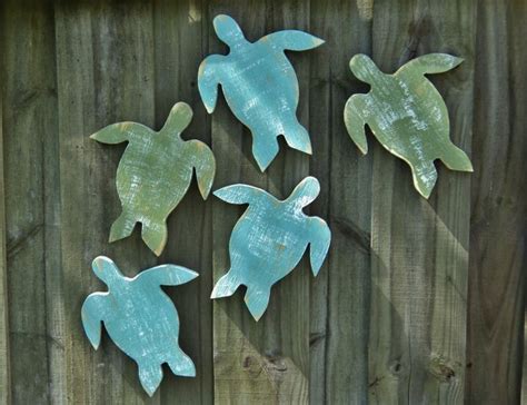 Four Sea Turtles Are Painted On The Side Of A Wooden Fence And One Is