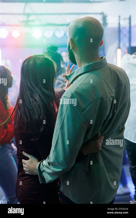 Young Couple Hugging And Standing On Dancefloor While Partying In