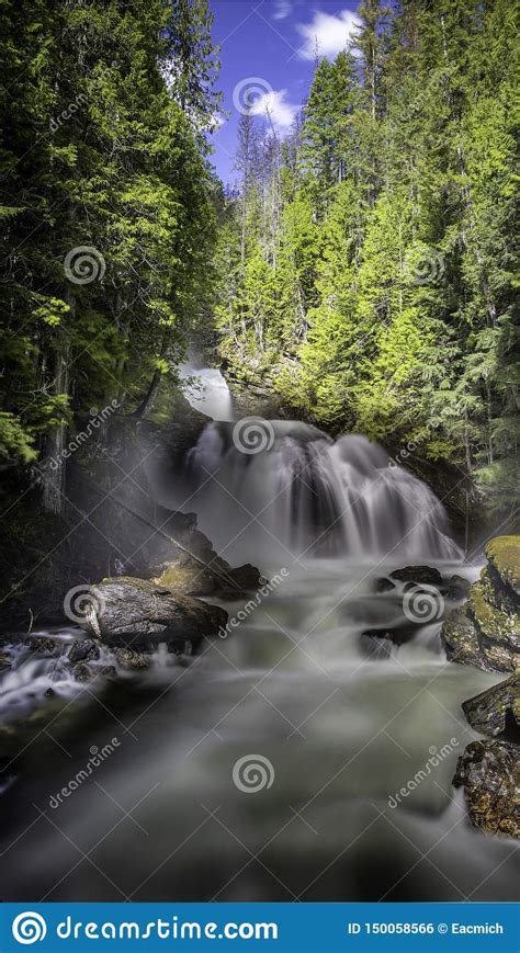 Long Exposure Waterfall Moss Covered Rocks Lush Green Forests Lit Up