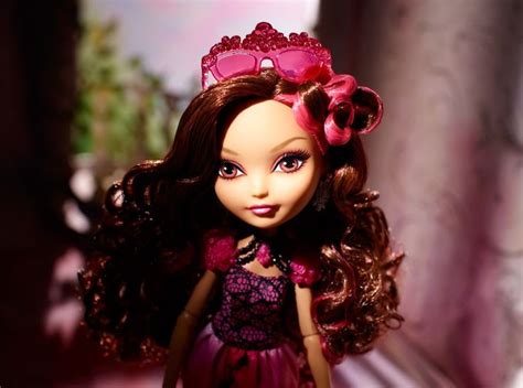 A Close Up Of A Doll Wearing A Dress And Headband With Flowers In Her Hair