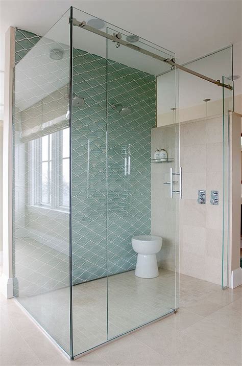 Floor To Ceiling Glass Shower With Diagonal Blue Tile Accent Wall