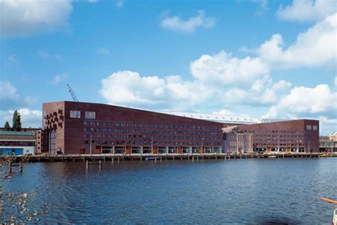 A Large Building Sitting Next To A Body Of Water
