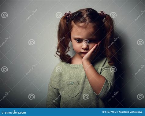 Sadness Kid Girl Looking Unhappy Closeup Portrait On Dark Stock Photo