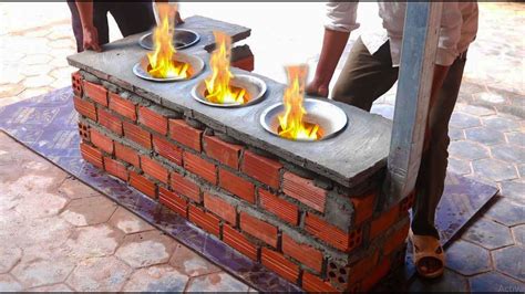 Three Bowls On Fire In The Middle Of A Brick Wall With Flames Coming