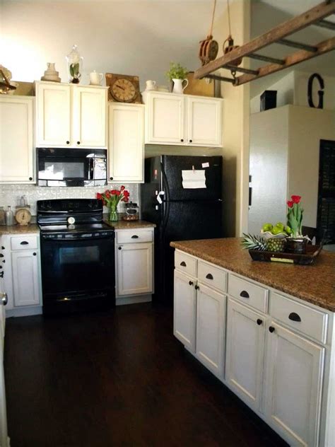 Cream kitchen cabinets with white subway tile on a budget. 50 Popular Wooden Black Kitchens Design | Kitchen cabinets with black appliances, Black ...