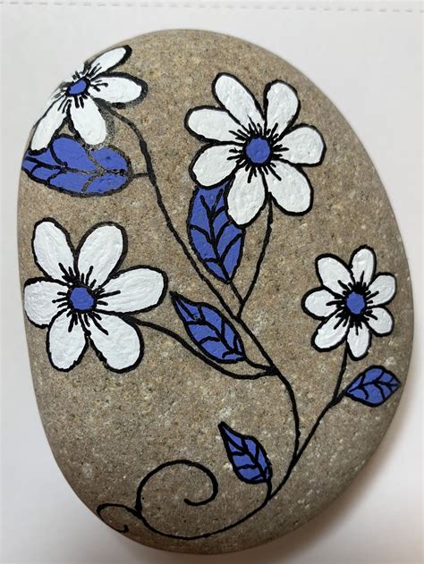 A Rock With Flowers Painted On It