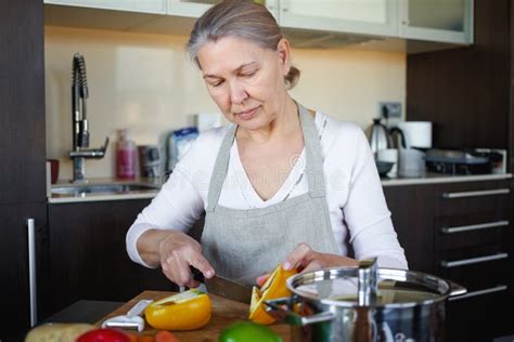 Mature Woman In Kitchen Preparing Food Stock Photo Image Of Aged