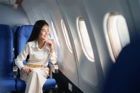 asian attractive business woman passenger sitting on business class luxury plane while relax