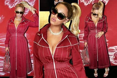 busty beyonce shows off her cleavage in a plunging red dress as she debuts bling dedicated to