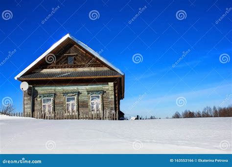 Old Wooden House And Snow Drifts In Winter In The Village On A Frosty