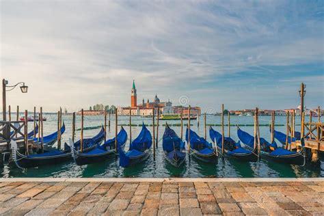 Venice Italy Pier With Moored Gondolas On Saint Mark Square With San