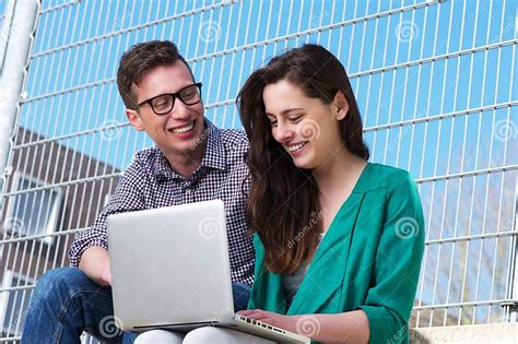 Two Students Working Together On Laptop Outdoors Stock Image Image Of