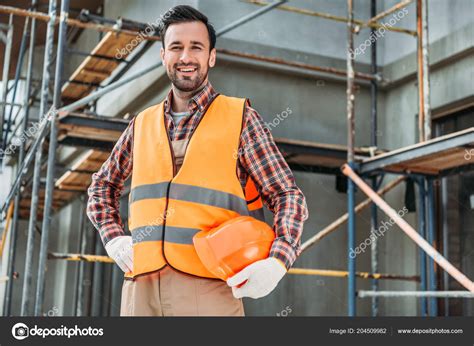 Happy Builder Reflective Vest Holding Helmet While Standing Front ...