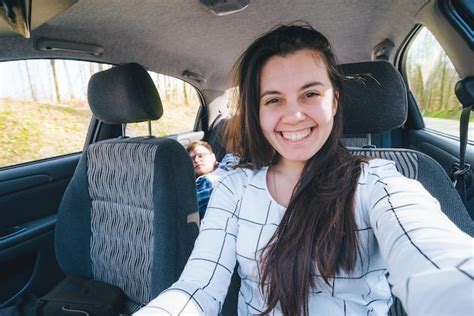 Premium Photo Woman Making Selfie While Driving Car With Slipping Man