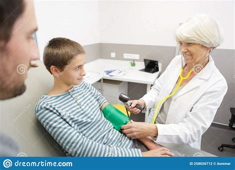 Mature Female Doctor Takes Childs Blood Pressure Stock Photo Image Of