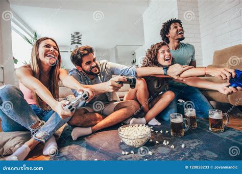 Group Of Friends Play Video Games Together At Home Having Fun Stock Image Image Of Leisure