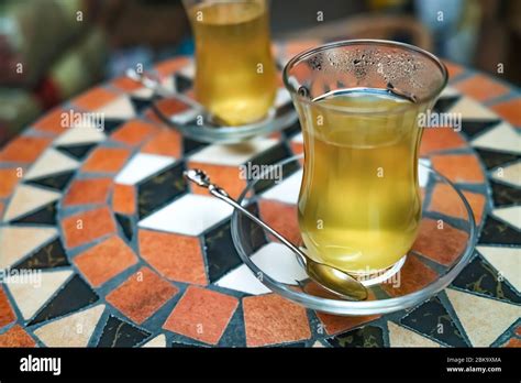 Traditional Turkish Fruit Tea Served In Glass Cups And Saucers On A