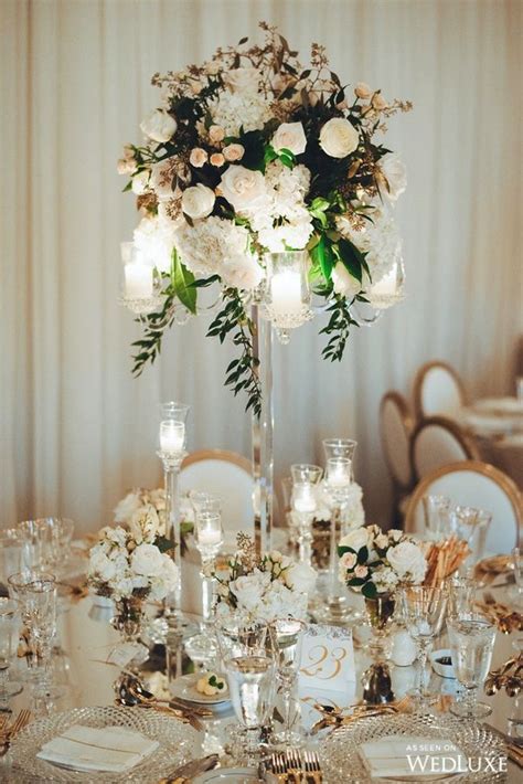 A Romantic Sky High Centerpiece Topped With Cascading Florals