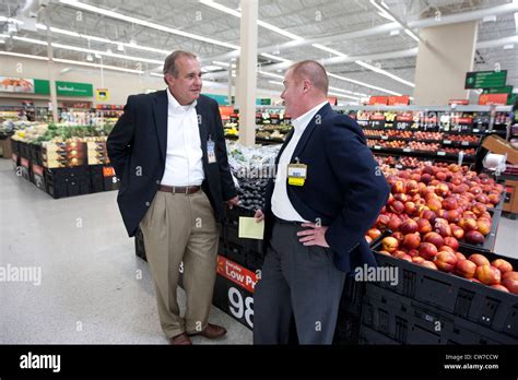 Two White Male Managers Of A Wal Mart Supercenter Talk In Produce