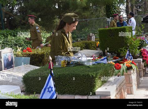 An Israeli Soldier Sits By The Graves Of Fallen Soldiers In The Mt