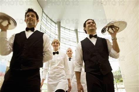 Group Of Waiters Carrying Trays Photo12 Tetra Images Seth Joel