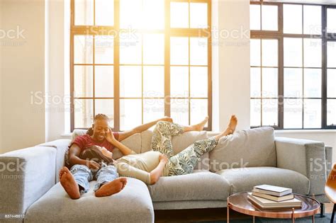 Pregnant Lesbian Couple Relaxing On Couch Stock Photo Download Image