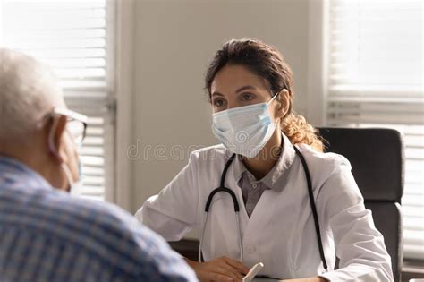 Female Doctor Consult Old Male Patient In Hospital Stock Photo Image