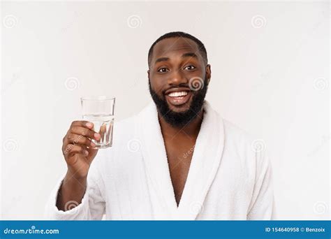 Thirsty Young African Man Holding Glass Drinking Water For Body Health
