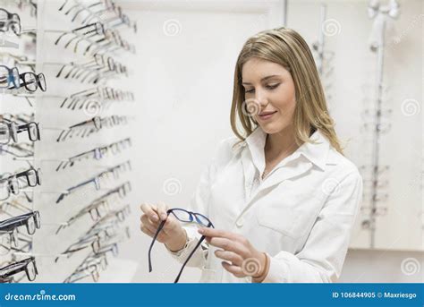 Optometrist Woman Looking Glasses At Display In Optical Store Wi Stock Image Image Of Doctor
