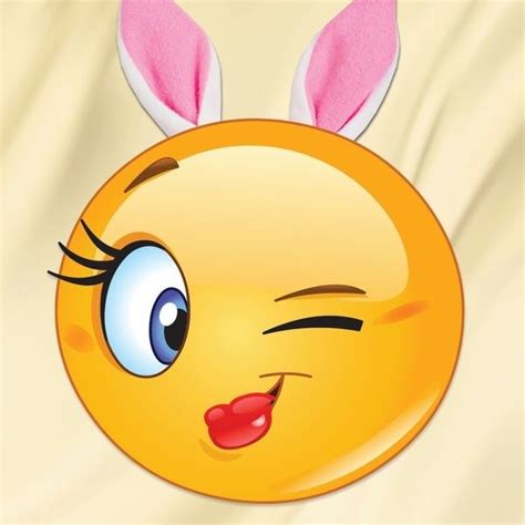 an emoticive smiley face with bunny ears