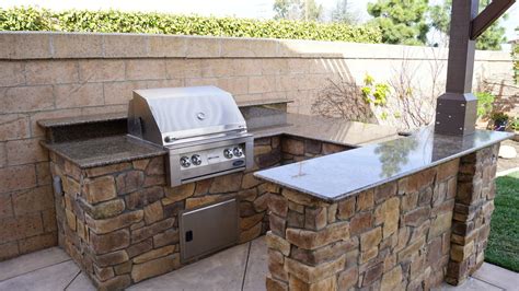 Rustic outdoor kitchen design with grill and dishwasher. Renovated Outdoor Kitchen Island with new Raised Bar, Faux ...