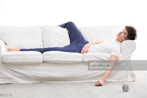 Young Man Sleeping On Couch Photo Getty Images