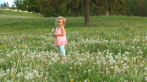 Child Dancing In Dandelion Flowers Mountains Girl Playing On Meadow