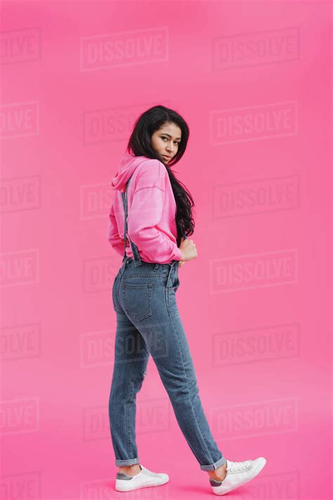 Stylish Young African American Woman In Denim Overall Posing On Pink
