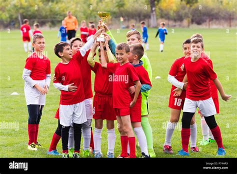 Kids Soccer Football Young Children Players Celebrating With A Trophy