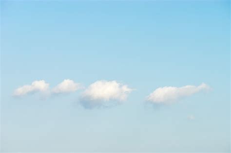 Premium Photo Puffy White Clouds Against Blue Sky Background
