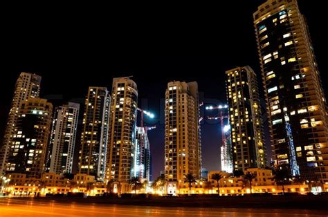 Colorful Night View Of City Of Dubai With Modern Downtown Buildings