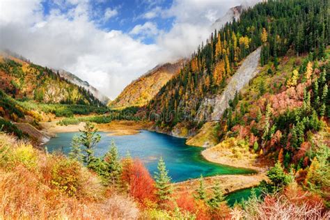The Upper Seasonal Lake Among Colorful Fall Woods And Mountains Stock