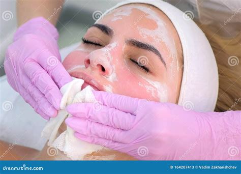 Cosmetologist In Gloves Wiping Mask From Woman`s Face Closeup Portrait