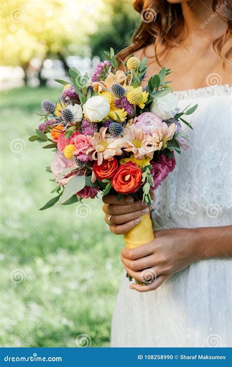 Beautiful Bride Holding Wedding Flower Bouquet In Hands Outdoors Stock