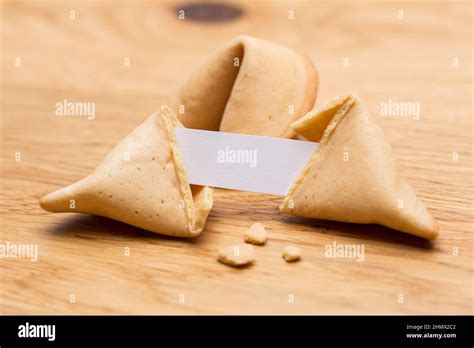 A Open Fortune Cookie With Note On Wooden Table Background Taken In