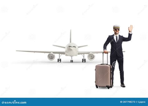 Pilot With A Suitcase In Front Of An Airplane Waving At Camera Stock