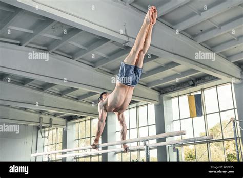 Male Gymnast Performing Handstand On Parallel Bars Stock Photo Alamy