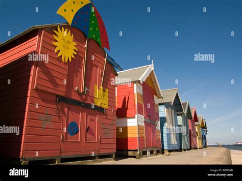 A Row Of Brightly Coloured Beach Huts On Cromer Seafront Stock Photo