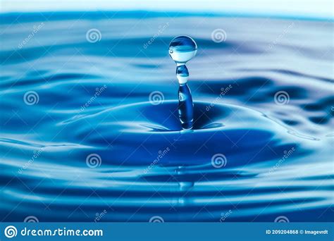 Dark Blue Water Droplets Splash Close Up On The Water Surface Stock